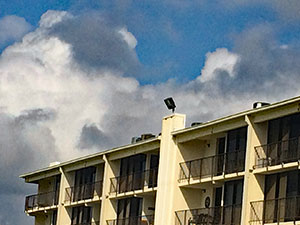 Top of condo spotlight directed at beach.
