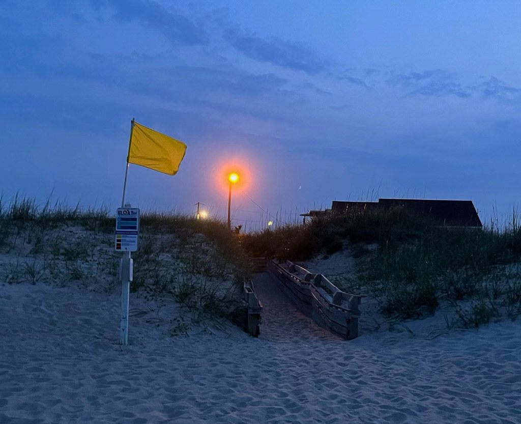 A bright light shining on the beach.