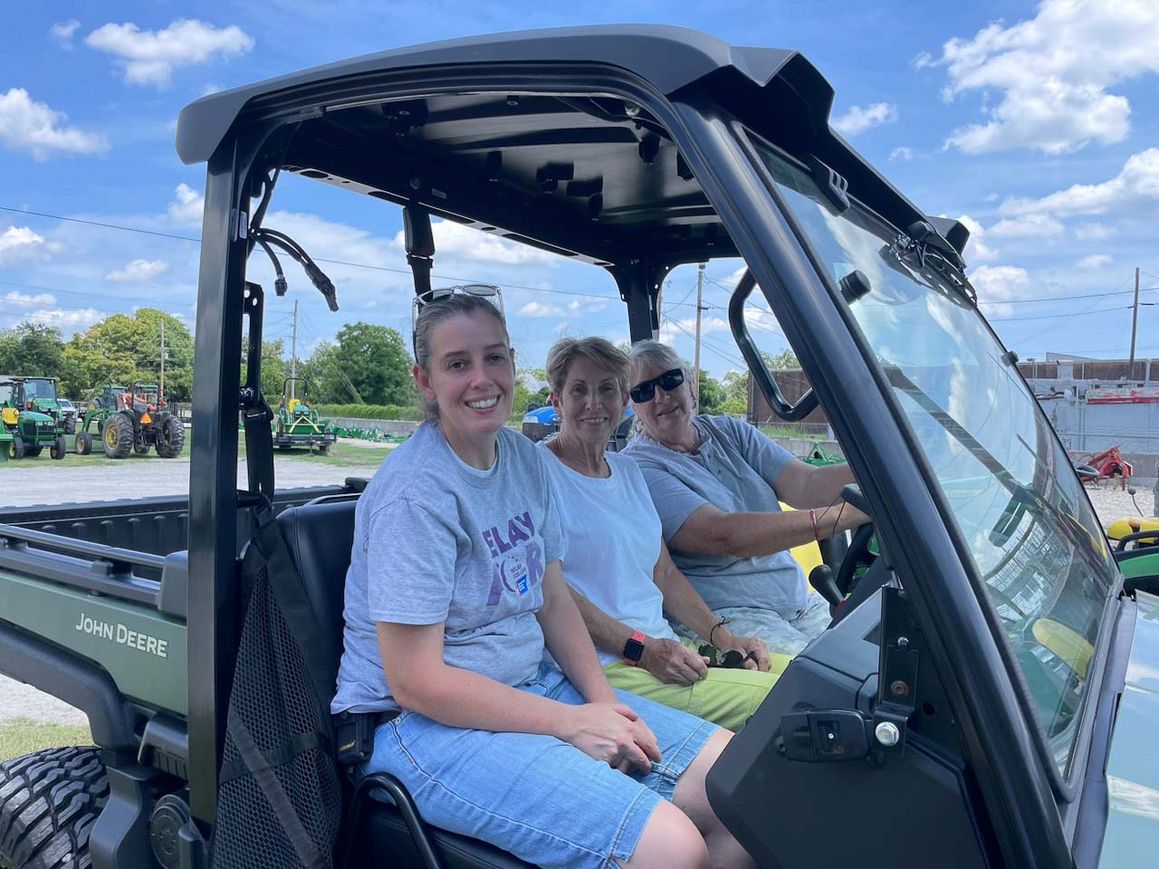 Three ABSTP volunteers in a UTV.