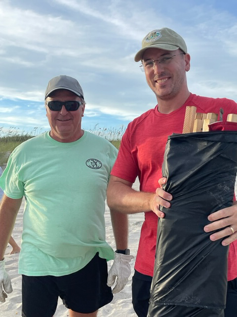 Volunteers installing black shade cloth around a sea turtle nest to protect hatchlings from light pollution.
